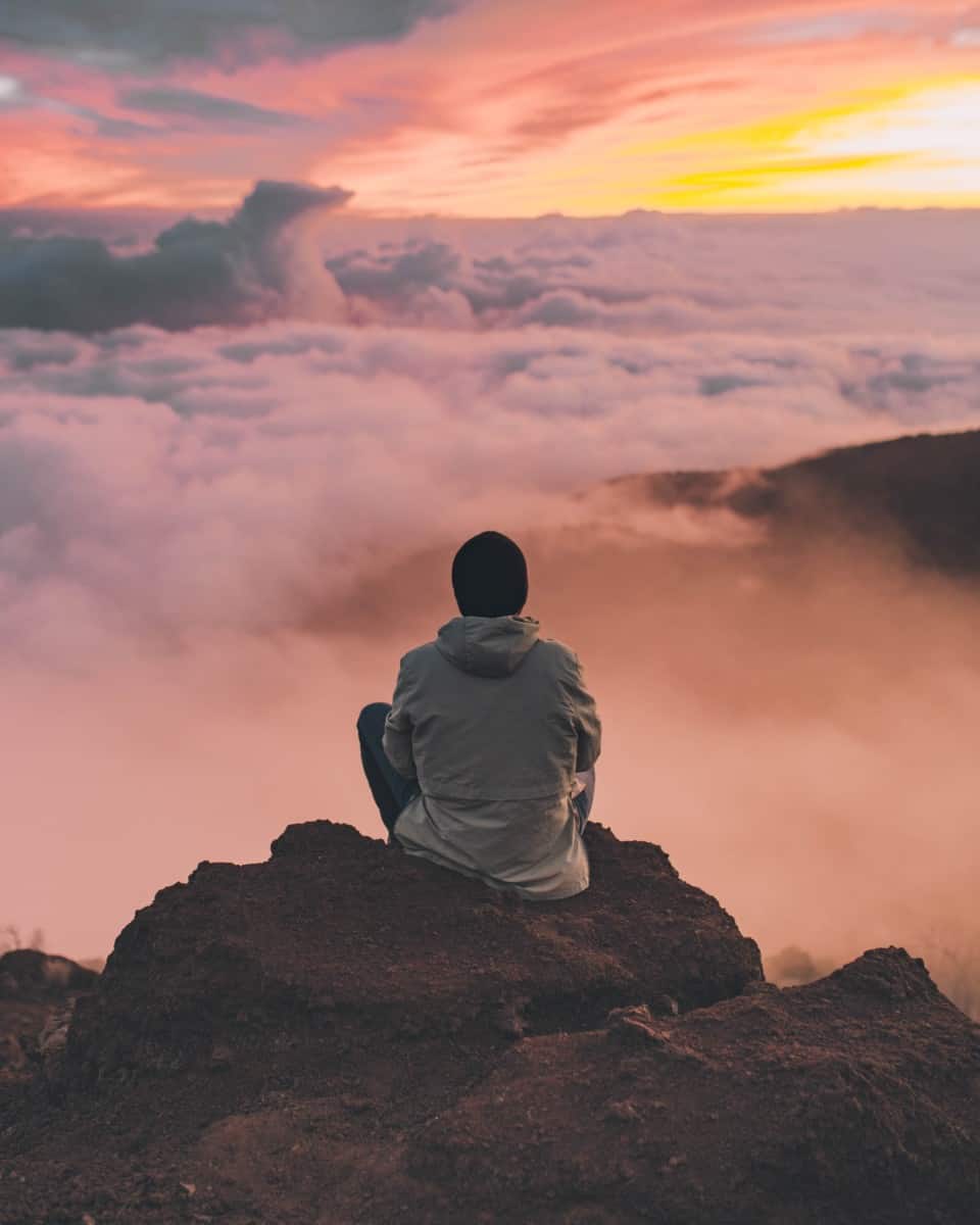 man looking out at clouds